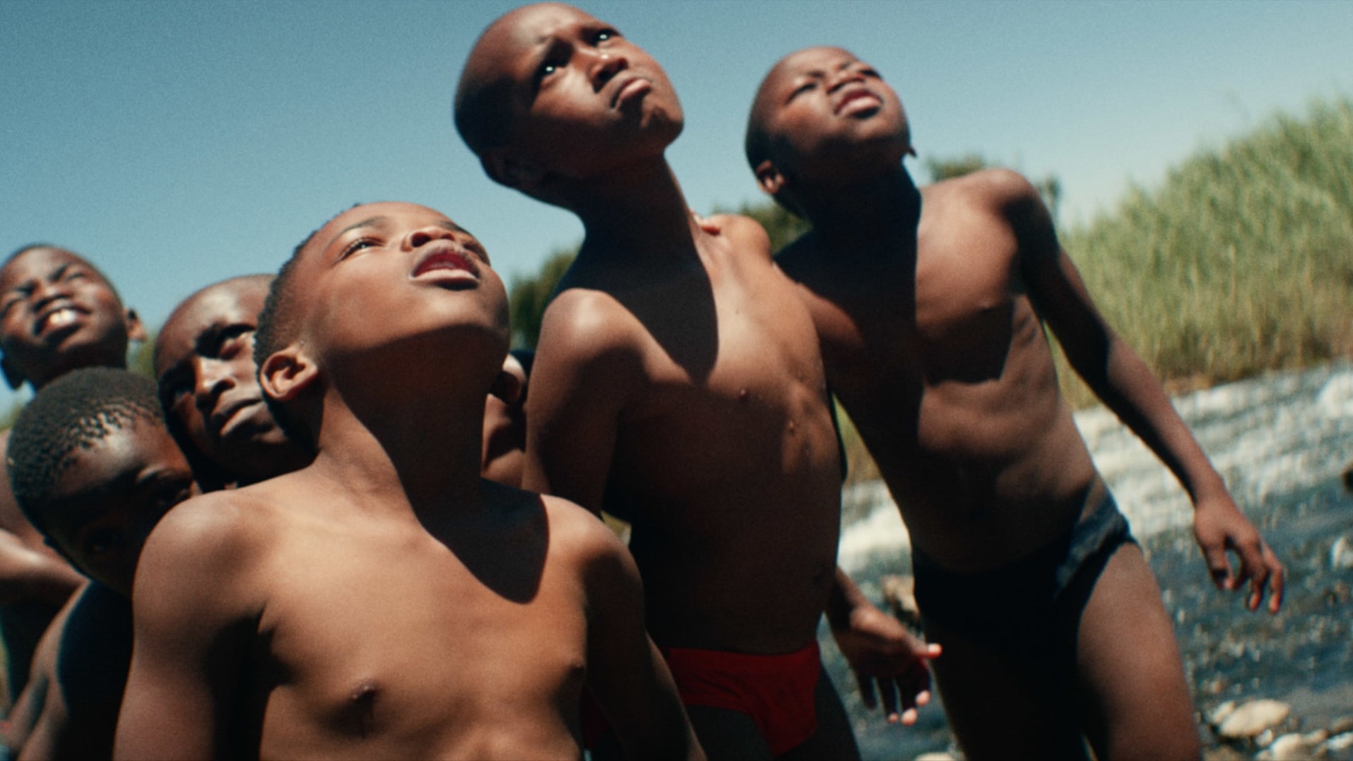 Jidenna 85 to Africa children looking upward in water thumbnail